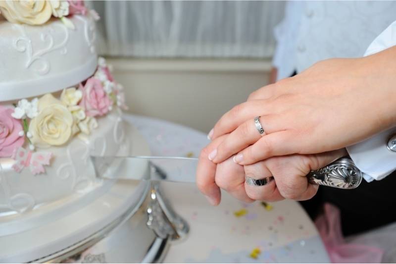 Bride & Groom Cutting Wedding Cake Hand on Hand